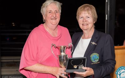Ann McShane  receives the trophy and top prize from Lady Captain Elana.